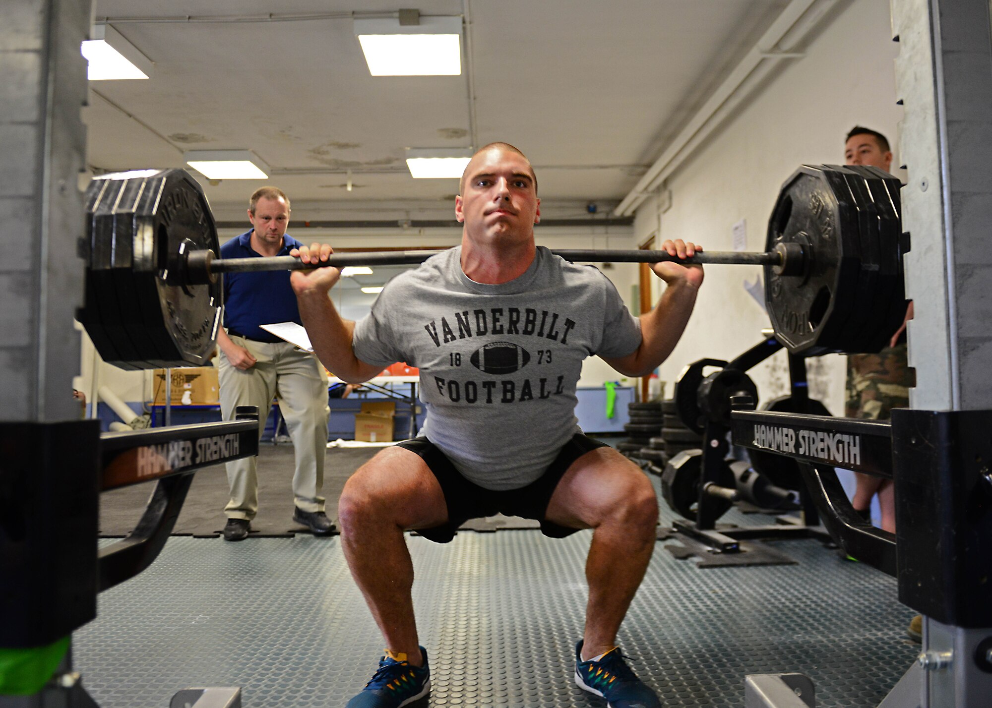 Airman 1st Class Matthew McKoin, 31st Security Forces Squadron, performs squats during a weight lifting competition, June 13, 2014, at Aviano Air Base, Italy. Participants competed in squats, bench press and dead lifts for the title for the strongest Team Aviano member. McKoin swept every category and lifted his way to the base’s strongest man title. (U.S. Air Force photo/Airman 1st Class Ryan Conroy) 