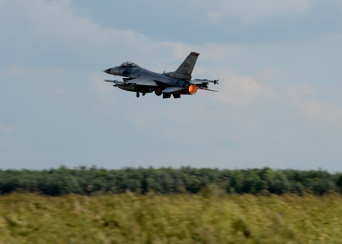 A U.S. Air Force F-16 Fighting Falcon fighter aircraft from the 52nd Fighter Wing, Spangdahlem Air Base, Germany, takes off from Lask Air Base, Poland, June 12, 2014. The U.S. pilots trained with their NATO partners during multinational Polish-led Exercise EAGLE TALON and U.S. Navy-led BALTOPS 14 in addition to U.S. Aviation Detachment Rotation 14-3. Exercises such as these help develop and improve a ready air force between NATO partners for future operations. (U.S. Air Force photo by Airman 1st Class Kyle Gese/Released)