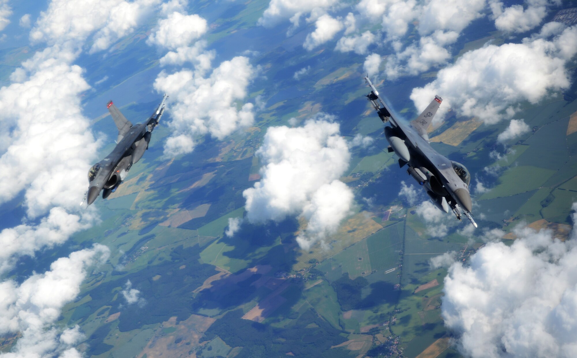 Two U.S. Air Force F-16 C/D Fighting Falcons peel-off after flying in a two-ship formation after taking on fuel from a KC-135 Stratotanker assigned to the 100th Air Refueling Wing during the Baltic Operations Exercise June 12, 2014, over Germany. The BALTOPS Exercise provides the opportunity for personnel of participating nations to engage in realistic training to build experience, teamwork and strengthen interoperability while working toward mutual goals. (U.S. Air Force photo/Airman 1st Class Dillon Johnston/Released)