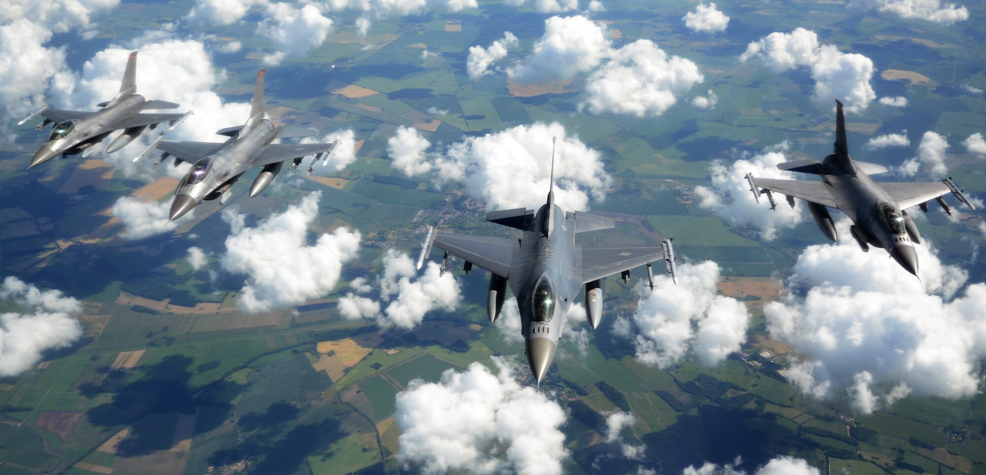 Four U.S. Air Force F-16 C/D Fighting Falcons fly in a four-ship formation after taking on fuel from a KC-135 Stratotanker assigned to the 100th Air Refueling Wing during the Baltic Operations Exercise June 12, 2014, over Germany. The BALTOPS Exercise demonstrates the U.S. Air Force’s commitment to its NATO allies and partners to promote peace and stability in the region. (U.S. Air Force photo/Airman 1st Class Dillon Johnston/Released)