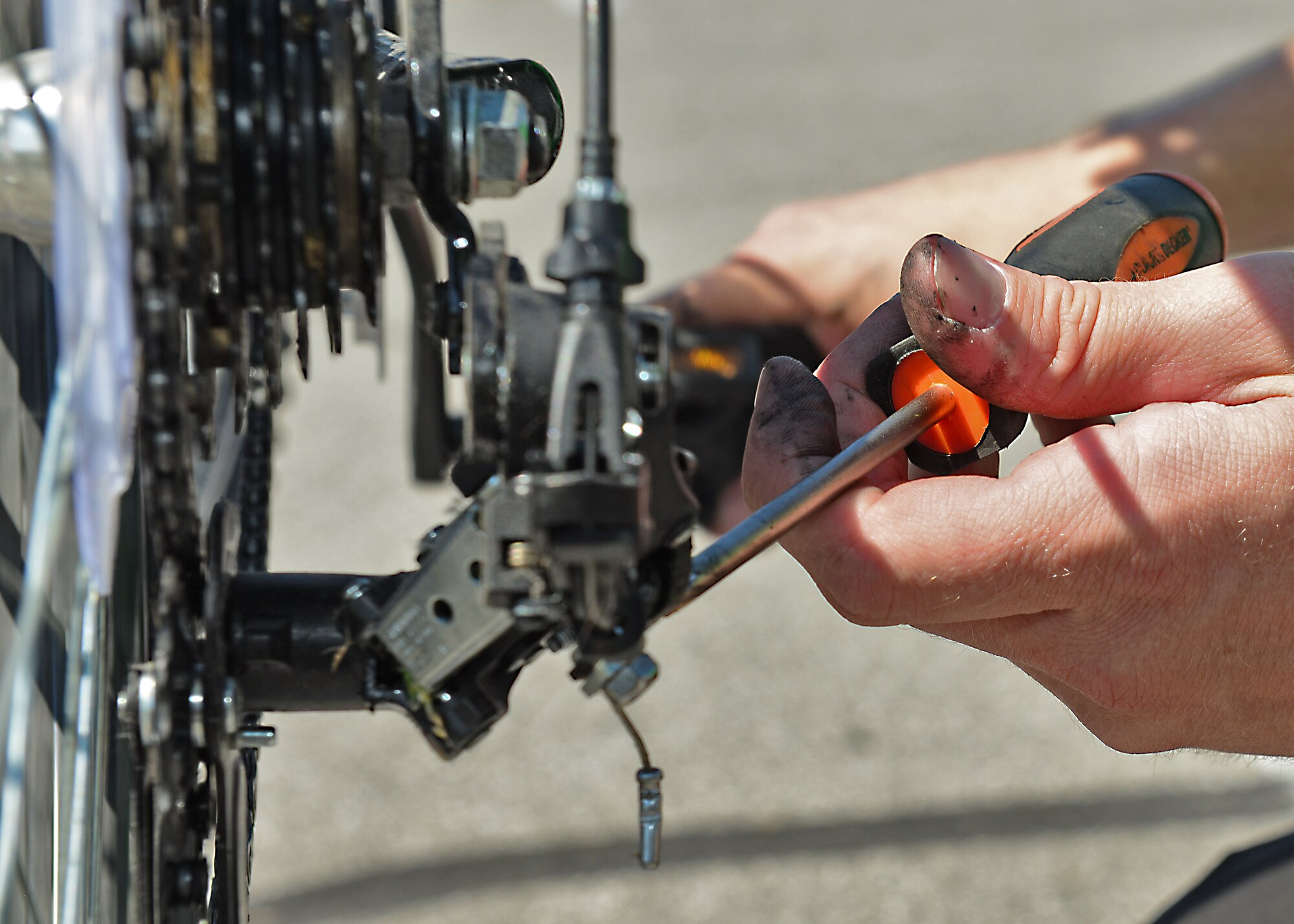 Tech. Sgt. Brandon Bourget, 31st Munitions Squadron, adjusts a bicycle chain during a two-day health festival, June 13, 2014, at Aviano Air Base, Italy. The Defense Commissary Agency’s Healthy Lifestyle Festival held from June 13-14 included a bike swap to encourage an active lifestyle. (U.S. Air Force photo/Airman 1st Class Ryan Conroy)  