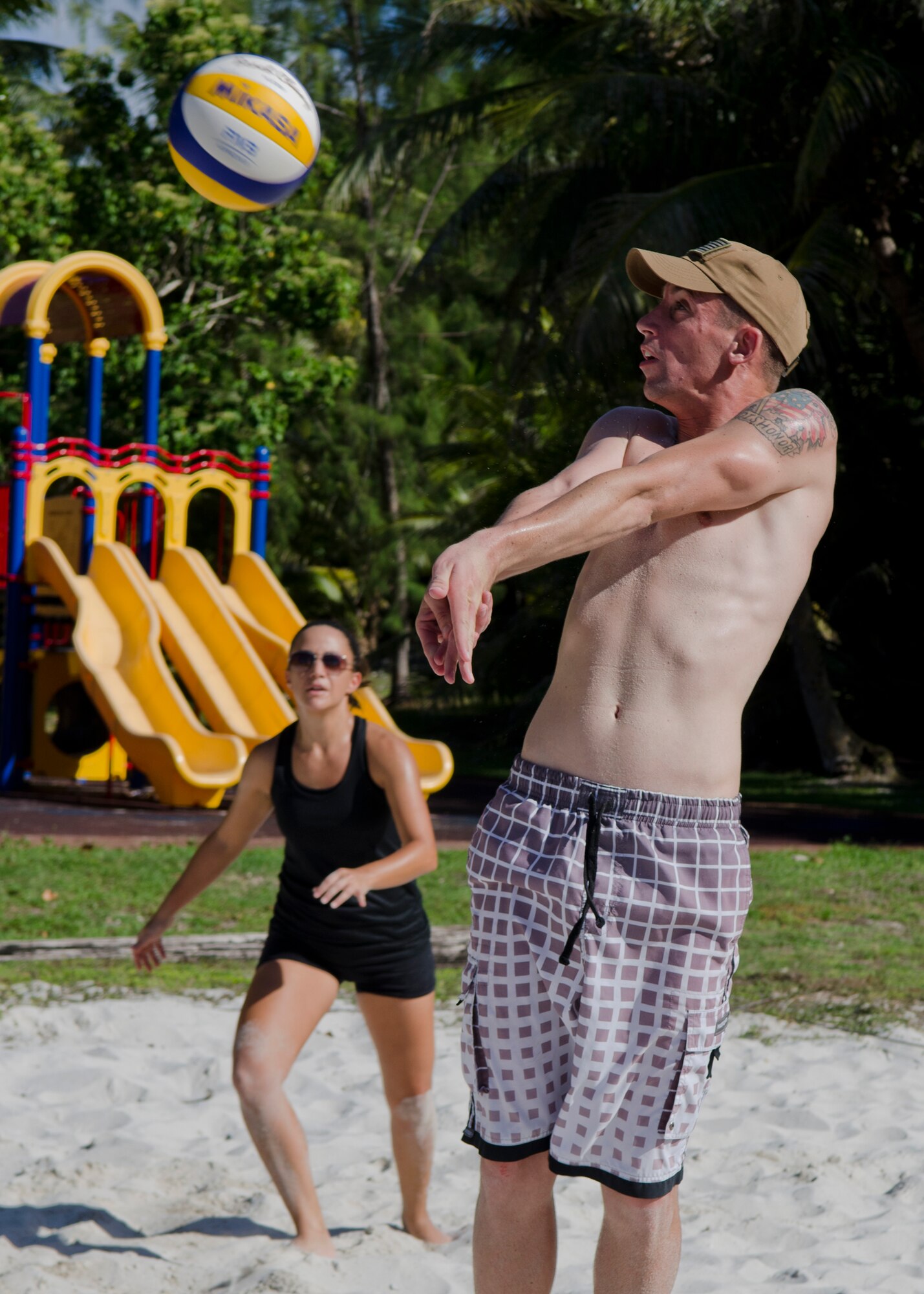 Tech. Sgt. Jeremy Stull, 736th Security Forces Squadron training instructor, sets up a teammate after returning a serve during the Tarague Beach Volleyball Tournament June 6, 2014, on Andersen Air Force Base, Guam. Along with bragging rights, each member of the tournament’s winning team received a trophy. (U.S. Air force photo by Senior Airman Katrina M. Brisbin/Released)
