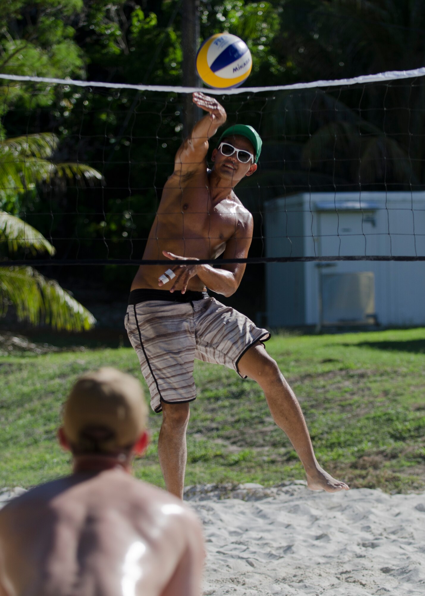 Jimmy Boonprakong, a Guam resident and Tarague Beach Volleyball Tournament participant, spikes a ball during a match June 6, 2014, on Andersen Air Force Base, Guam. More than two dozen players participated in the 36th Force Support Squadron-hosted tournament. (U.S. Air Force photo by Senior Airman Katrina M. Brisbin/Released)
