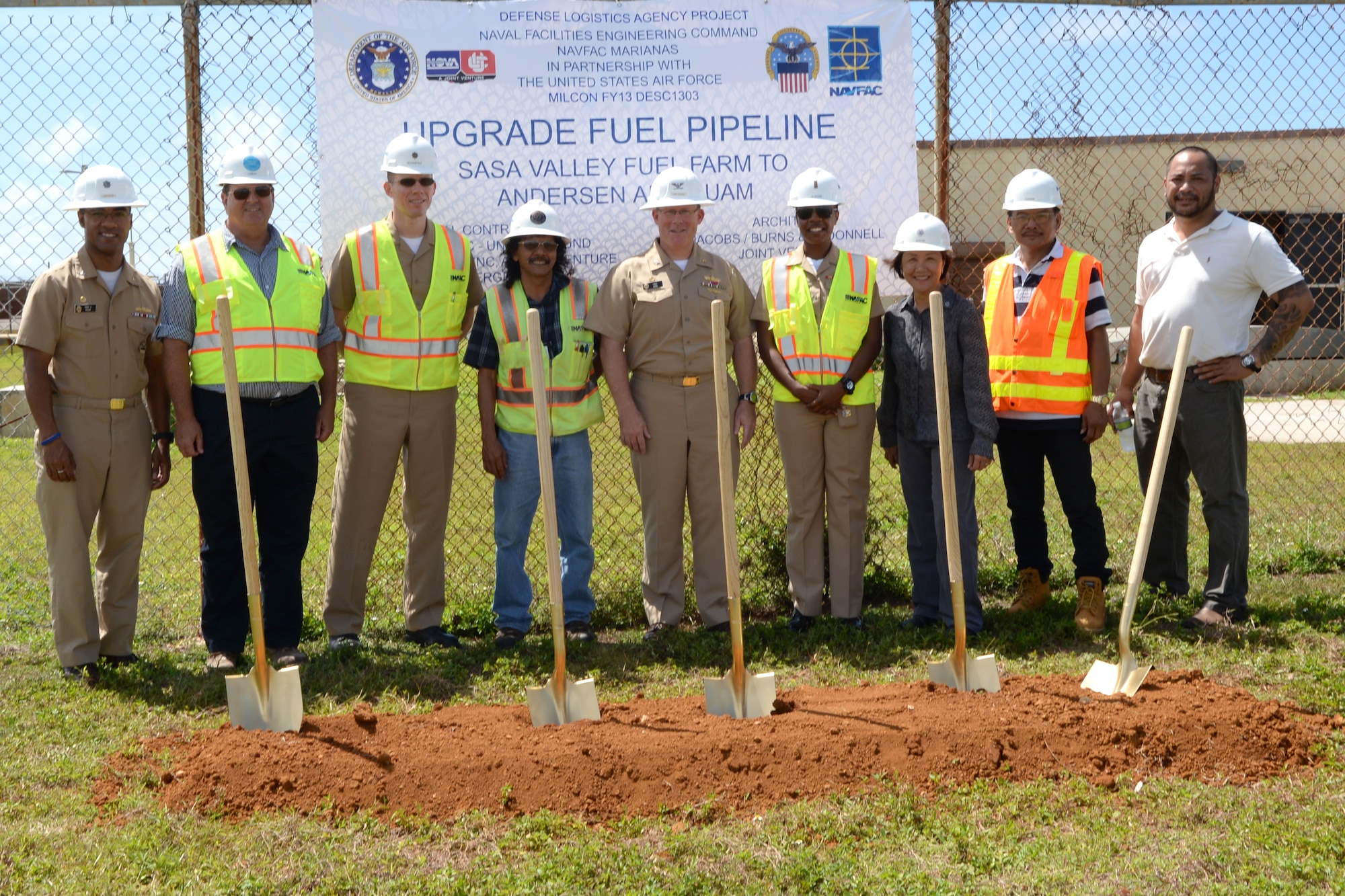 Team members from the Defense Logistics Agency pose with U.S. Navy Capt. Christopher Bower, DLA Energy Pacific commander (center) at the site of a fuel pipeline groundbreaking June 6, 2014 on Andersen Air Force Base, Guam. The team cleared 10 years of administrative hurdles to begin work on the $62 million, 15.7 mile project estimated to be completed in June 2016. (U.S. Air Force photo by Tech. Sgt. Zachary Wilson/Released.)