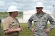 U.S. Air Force Brig. Gen. Steven Garland discusses the start of a new fuel pipeline project with U.S. Navy Capt. Christopher Bower, Defense Logistics Agency Energy Pacific commander June 6, 2014 on Andersen Air Force Base, Guam. Coordination for the project began 10 years ago and the joint team of DLA, Joint Region Marianas and other defense supporting agencies cleared several administrative hurdles to allow construction to begin on a $62 million, 15.7 mile fuel pipeline. (U.S. Air Force photo by Tech. Sgt. Zachary Wilson/Released)