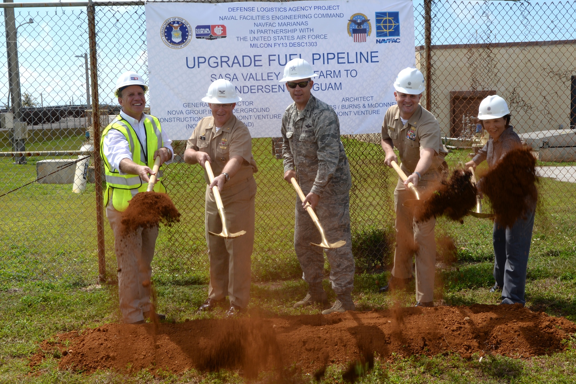 Chris Matheis, construction executive, U.S. Navy Capt. Christopher Bower, Defense Logistics Agency Energy Pacific commander, U.S. Air Force Brig. Gen. Steven Garland, 36th Wing commander, U.S. Navy Cmdr. Kevin Juntenen, Naval Facilities Engineering Command Marianas Operations officer, and Nympha Garces, DLA Installation Support engineer, break ground on a new fuel pipeline with representatives from the Defense Logistics Agency June 6, 2014 on Andersen Air Force Base, Guam. The $62 million project kicks off the construction of a 15.7 mile pipeline that will cross the island. (U.S. Air Force photo by Tech. Sgt. Zachary Wilson/Released)