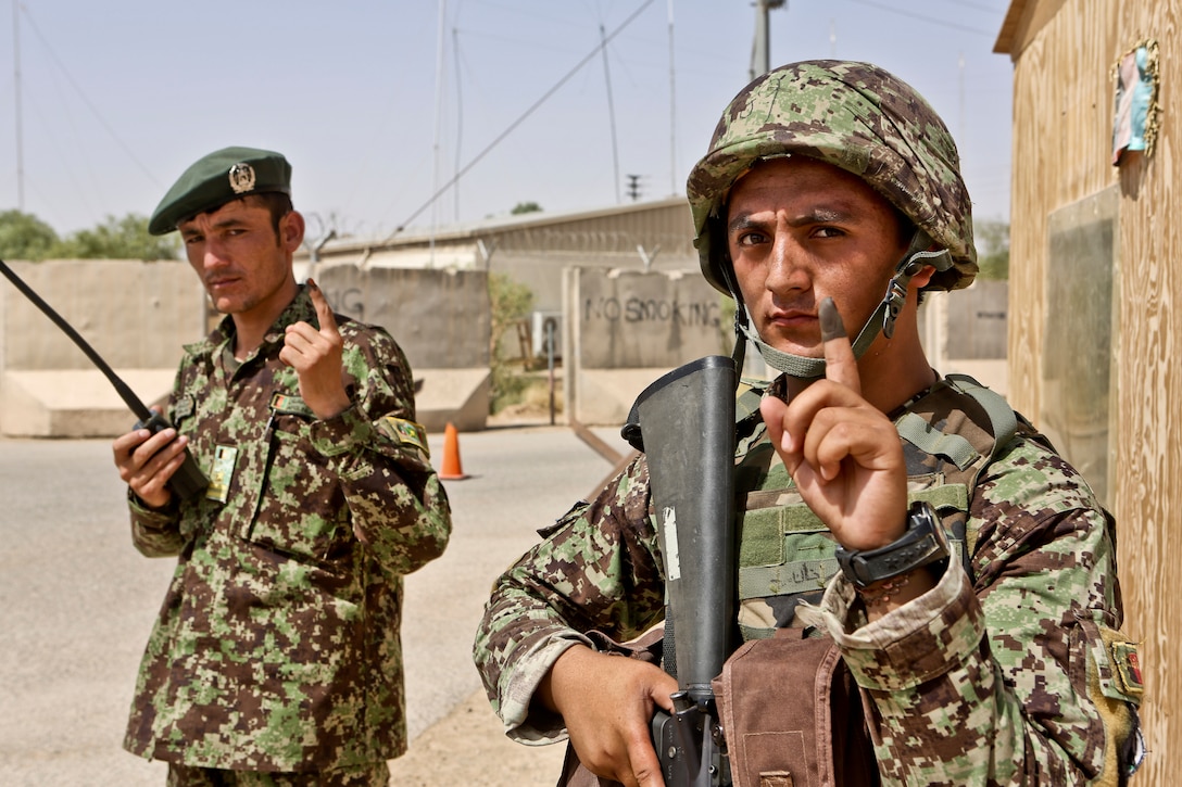 Afghan soldiers assigned to the 215th Corps display their inked index ...