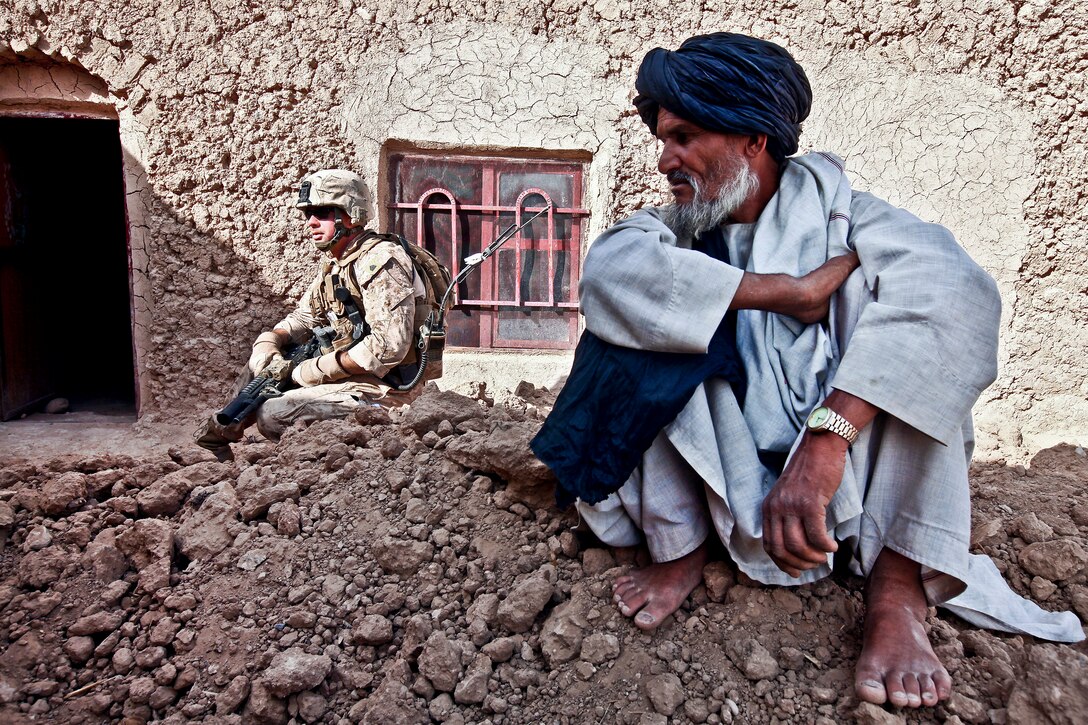 U.S. Marine Corps Sgt. Josh Coldwell collects information from Afghan villagers during a patrol in the southern portion of the Washir district in Afghanistan's Helmand province, Oct. 4, 2011. Coldwell is assigned to Mobile Assault Platoon 4, Weapons Company, 1st Battalion, 25th Marine Regiment.  
