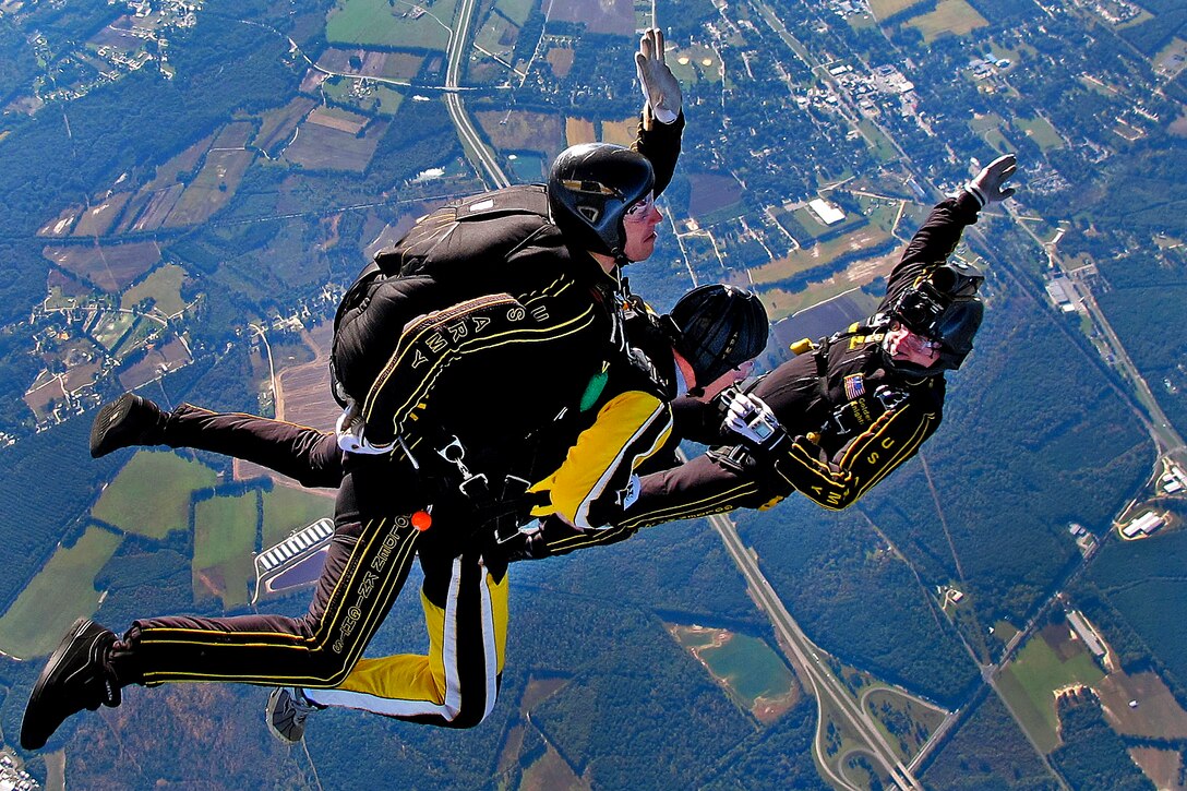 A photographer with the Army Golden Knights Parachute Team videotapes Sgt. Alan Farr during a tandem jump over Laurinburg, N.C., Oct. 17, 2011. Farr is a paratrooper assigned to the 82nd Airborne Division's 1st Brigade Combat Team.  
