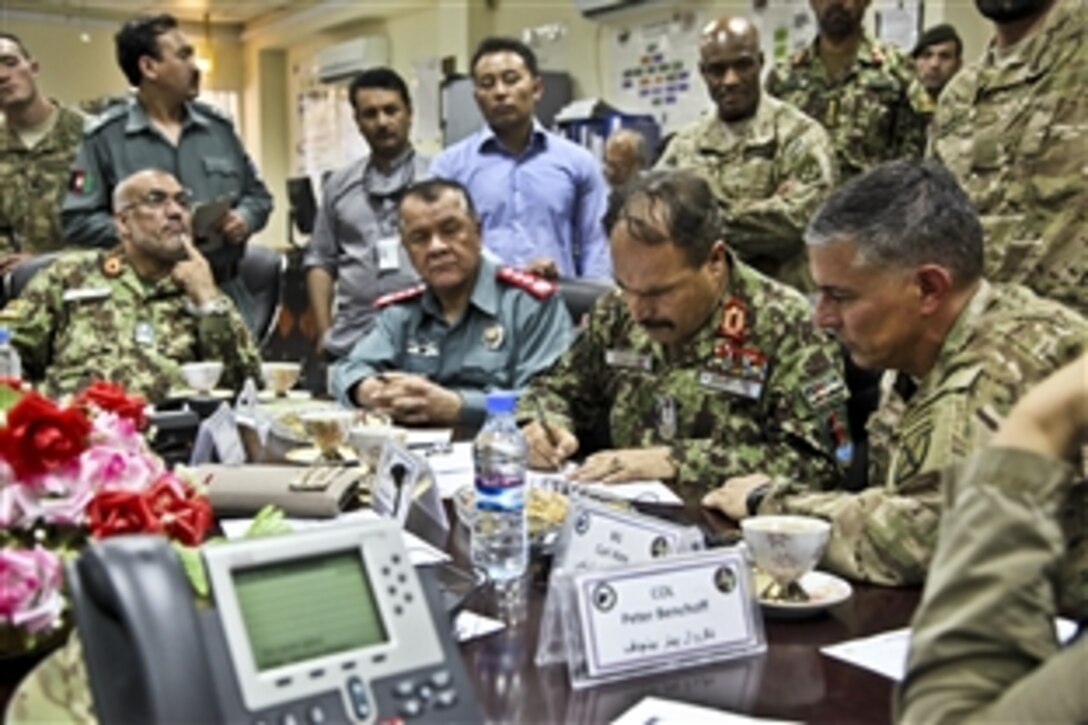 Afghan security forces await presidential runoff election results and plan counterinsurgency tactics as U.S. members of the International Security Assistance Force assist in the operations center on Forward Operating Base Gamberi in Afghanistan's Laghman province, June 14, 2014. Afghan forces were responsible for ensuring the safety of the Afghan people during the elections.