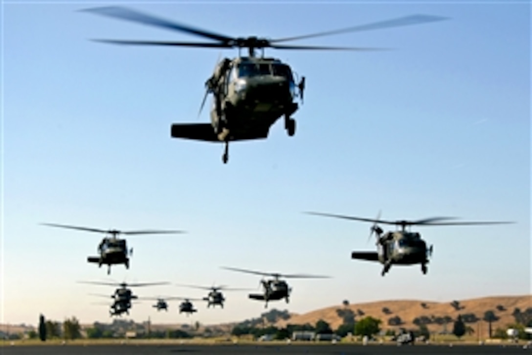 UH-60 Black Hawk helicopters lift off in a tactical formation from Camp Roberts, Calif., June 15, 2014, to pick up soldiers for an air assault mission. The helicopter crews are assigned to the 1st Battalion, 140th Aviation Regiment, 40th Combat Aviation Brigade.