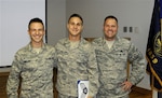 Air Force Senior Airman Zachary Phillips, center, is promoted to his present rank June 7, 2014, at a ceremony on the Portland Air National Guard Base, Ore. His brother, Air Force Senior Airman Lewis Phillips, left, and their father, Air Force Senior Master Sgt. John Phillips participated in the ceremony. 