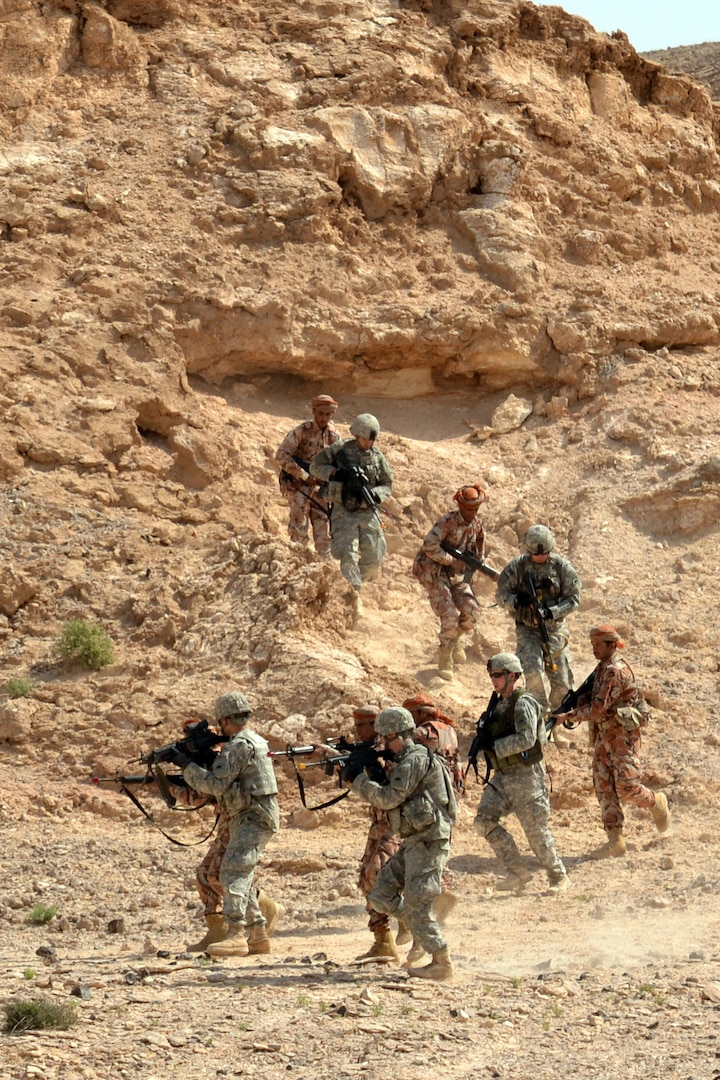 Soldiers from the Oregon National Guard's 1st Squadron, 82nd Cavalry Regiment, and Omani soldiers from the Royal Army of Oman's 11th Brigade, Western Frontier Regiment, move toward their objective during a squad assault training exercise at the Rubkut Training Range in Oman, Jan. 24, 2012. The two-week exercise, sponsored by U.S. Army Central, was meant to share knowledge and build diplomatic relations between the U.S. military and Oman.
