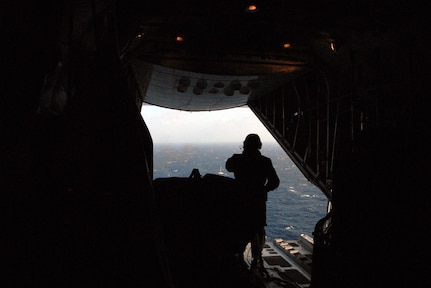 A Coast Guard drop master prepares to drop medical supplies to the Clipper Venture 6, a 67-foot sailing yacht, Saturday, March 31, 2012. The Rescue Coordination Center in Alameda, Calif. is coordinating the rescue efforts of three injured boaters.