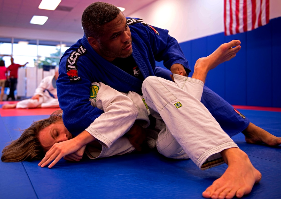 Kelly Grissom, a Brazilian Jujitsu instructor, demonstrates a technique on a Brazilian Jujitsu student at his martial arts school, KOA, in Stafford, Va., June 6, 2014. Kelly Grissom co-founded the Lion Heart Initiative, a plan to teach mixed martial arts to young urban youth of Senegal, West Africa, and create better opportunities for them.