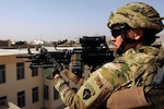 Alaska Army National Guard member Pfc. Laurence Yeaton, provides security while members of the Kandahar Provincial Reconstruction Team's engineering department conduct a site assessment of a future midwifery facility March 6, 2012 in Kandahar, Afghanistan.