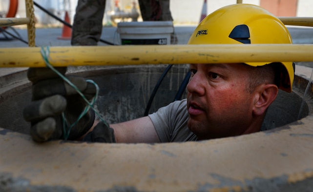 Staff Sgt. Lawence Santos intalls a cable shoe May 15, 2014, at Bagram Airfield, Afghanistan. The cable shoe will help prevent damage to the cable from rough or sharp surfaces. Santos, a East Taunton, Mass. native is a Combined Air and Space Operations Center Engineering and Installations cable and antenna technician, deployed from the 212th Engineering and Installation Squadron, Otis Air National Guard Base, Mass. (U.S. Air Force photo/Senior Airman Sandra Welch)