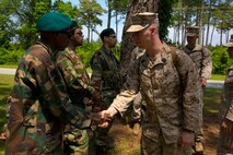 A hospital corpsman with Combat Logistics Battalion 2 shakes hands with a role player during a mission rehearsal exercise aboard Marine Corps Auxiliary Landing Field Bogue, N.C., June 10, 2014. Service members trained with role players from SpecPro Technical Services with the help of Marine Corps Security Cooperation Group to increase the unit’s readiness before an upcoming deployment for the next rotation of Special Purpose Marine Air Ground Task Force Africa.


