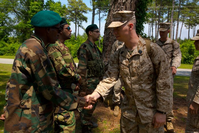 A hospital corpsman with Combat Logistics Battalion 2 shakes hands with a role player during a mission rehearsal exercise aboard Marine Corps Auxiliary Landing Field Bogue, N.C., June 10, 2014. Service members trained with role players from SpecPro Technical Services with the help of Marine Corps Security Cooperation Group to increase the unit’s readiness before an upcoming deployment for the next rotation of Special Purpose Marine Air Ground Task Force Africa.


