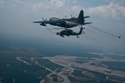JOINT BASE ELMENDORF-RICHARDSON, Alaska (June 8, 2014) - A HC-130P refuels a HH-60 Pave Hawk helicopter during the Joint Forcible Entry Exercise at Donnelly Training Area near Fort Greely Sunday. The exercise was part of a three-day, joint forcible-entry exercise to train on airfield seizure operations. (U.S. Army photo/Sgt. Eric-James Estrada)140608-A-ZD229-458
