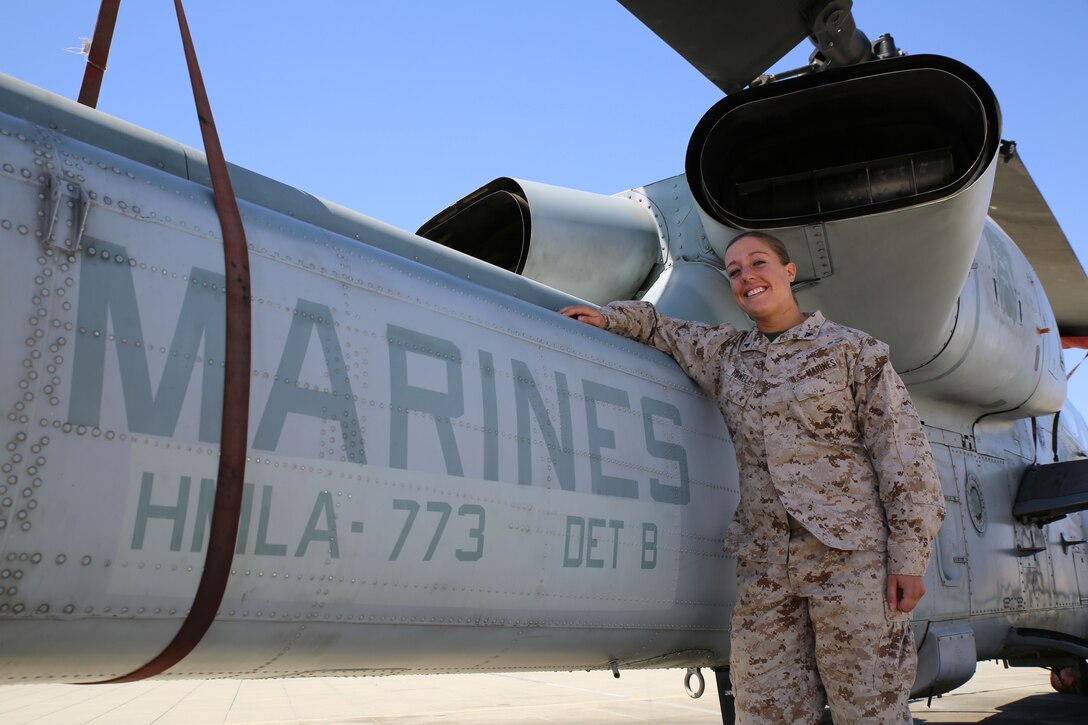 Lance Cpl. Danielle E. Howell, an aviation maintenance data specialist with Marine Light Attack Helicopter Squadron 773, stands next to an AH-1 Cobra helicopter during Integrated Training Exercise 4-14, June 14, 2014. ITX 4-14 employs assets from ground, air and logistics combat elements to demonstrate the ability to deploy rapidly and build up significant combat power necessary to form a Marine Air-Ground Task Force. Howell recently earned her master’s degree in social work in her pursuit to help heal mentally wounded veterans returning from war.
