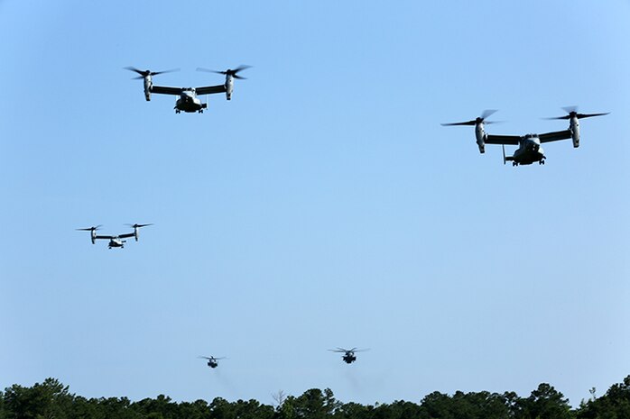 Three MV-22B Ospreys and two CH-53E Super Stallions from Marine Medium Tiltrotor Squadron 365 (Reinforced), 24th Marine Expeditionary Unit, prepare to drop off 24th MEU Marines and Sailors with Battalion Landing Team 3rd Battalion, 6th Marine Regiment during a vertical assault raid course at Camp Lejeune, N.C., June 17, 2014. The assault was part of Lima Company, BLT 3/6’s pre-deployment training in preparation for the 24th MEU’s deployment at the end of the year. (U.S. Marine Corps photo by Cpl. Devin Nichols)