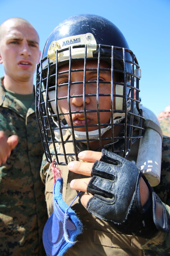 Recruit Horacio J. Sotelo, Platoon 1065, dons his helmet in preparation for a pugil sticks match at Marine Corps Recruit Depot San Diego, June 12. Sotelo, is a native of De Queen, Ark., and was recruited from Recruiting Sub Station Texarkana, Texas.