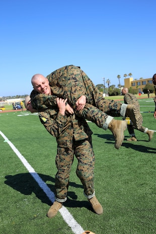 Recruit Tristan B. Butler, Platoon 2163, Hotel Company, 2nd Recruit Training Battalion, conducts a fireman’s carry during the Combat Fitness Test at Marine Corps Recruit Depot San Diego, June 11. Partners for their event must be within 10 pounds of each other’s weight.