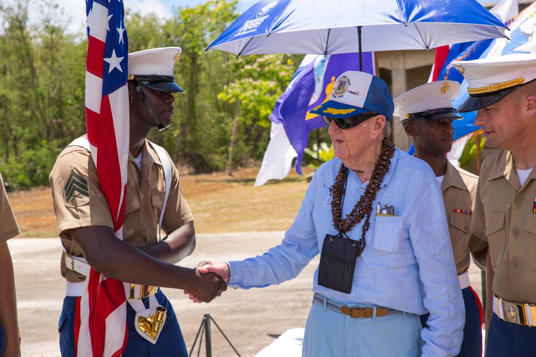 Retired U.S. Army Air Corps Lt. Col. Raymond Russell Kelly, right, shakes hands with U.S. Marine Sgt. Andre M. Thomas June 12 at the historic North Field, Tinian, after the 70th Anniversary Reunion of Honor ceremony. The ceremony is part of a weeklong celebration paying tribute to both American and Japanese veterans of the battles of Saipan and Tinian during World War II. Kelly was the distinguished guest of honor at the ceremony as he was stationed at Tinian during the war. Kelly took part in more than 35 missions over Japan and was happy to report that although his crew’s aircraft was badly damaged during their missions, neither he nor his crew members were harmed. Kelly was a radar operator with the 482nd Squadron, 505th Bomb Group, 313th Bomb Wing, stationed at Tinian's North Field and is a resident of Santa Rosa, Calif. Thomas is an automotive organizational technician with Headquarters Battalion, 3rd Marine Division, III Marine Expeditionary Force, and a native of Miami, Florida. (U.S. Marine Corps photo by Cpl. Adam B. Miller/Released)