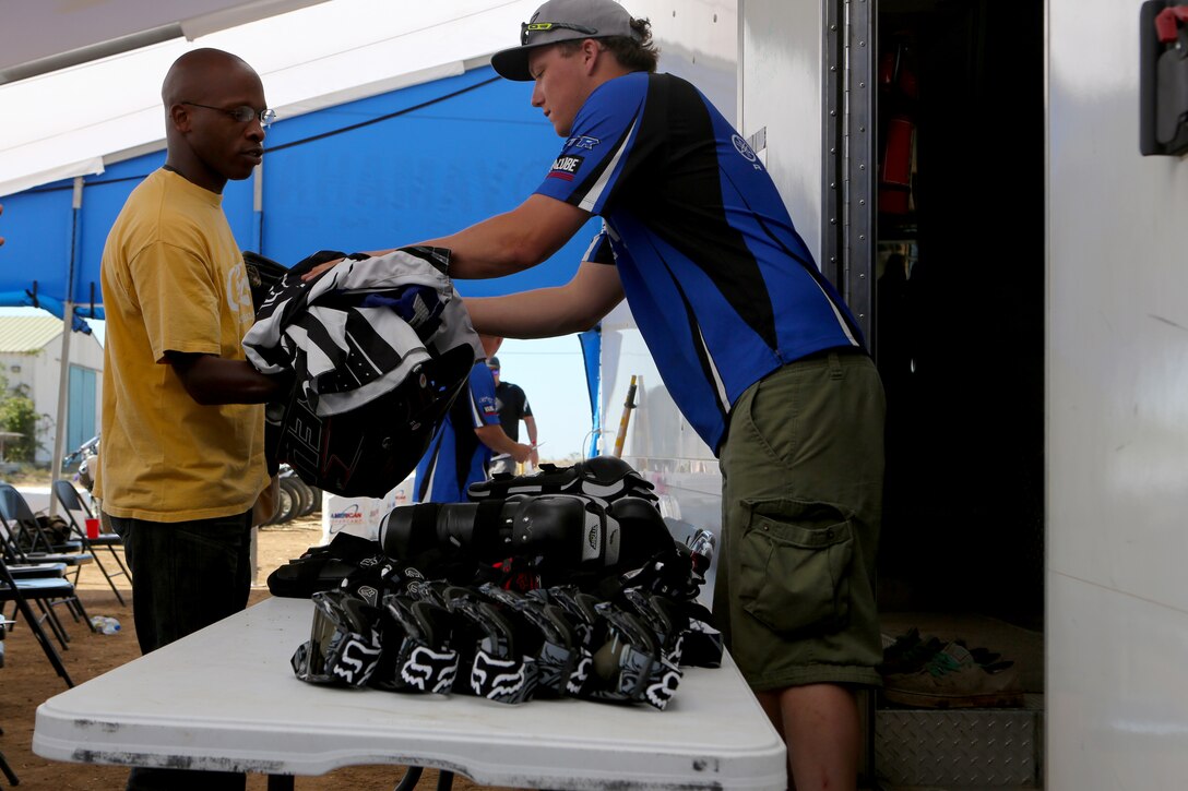 Gunnery Sgt. Corey Cooper, a radar technician with Headquarters and Headquarters Squadron, receives his riding equipment during an American Supercamp course aboard Marine Corps Air Station Miramar, Calif., June 16. The two-day course taught students the proper way to handle a bike in adverse conditions.