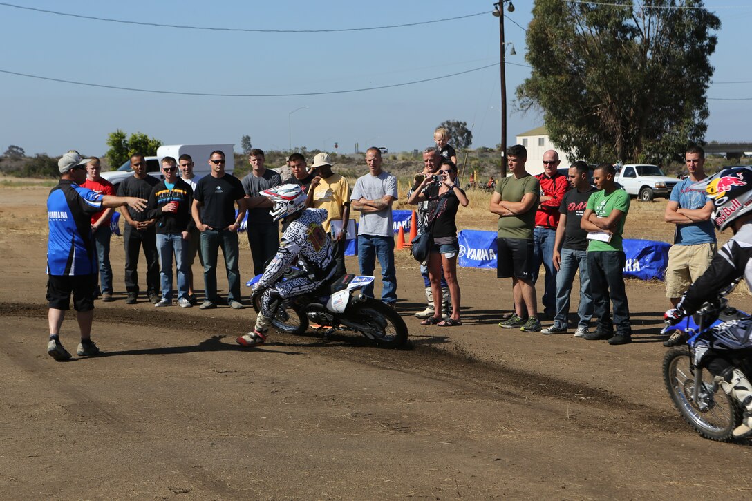 Marines observe the proper way to ride around the track during an American Supercamp course aboard Marine Corps Air Station Miramar, Calif., June 16. The two-day course taught Marines how to control their motorcycles when in different conditions and terrains. 	