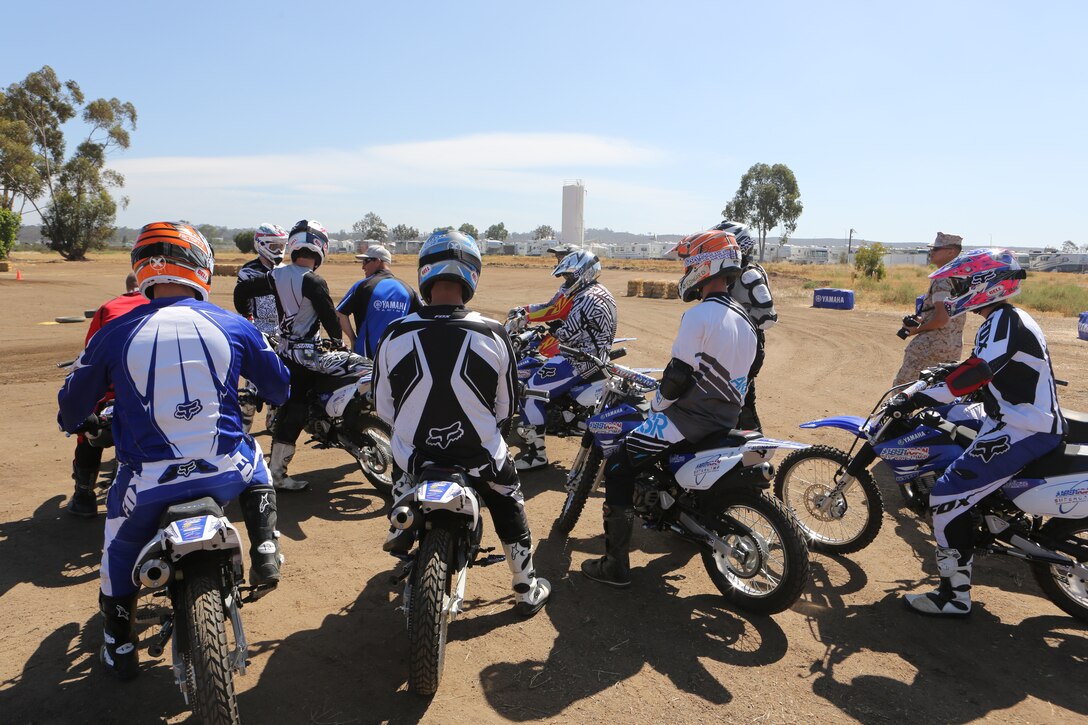Marines listen to a period of instruction during an American Supercamp course aboard Marine Corps Air Station Miramar, Calif., June 16. The course taught Marines how to handle their motorcycles during dangerous situations while on the road.