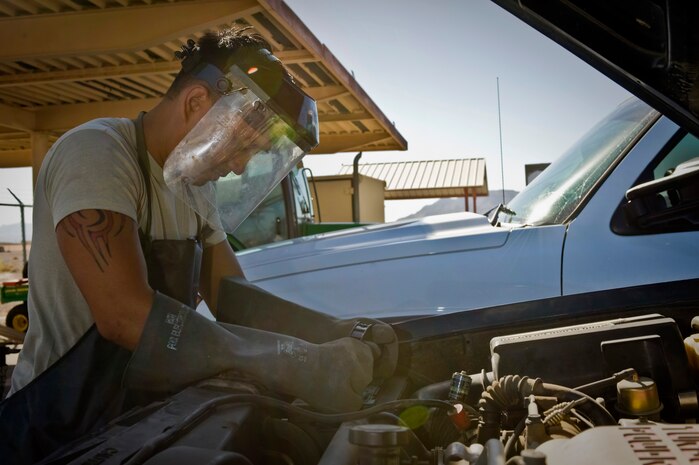 Staff Sgt. Francisco Macatol, 99th Logistics Readiness Squadron customer service technician, replaces a battery on a telephone maintenance truck June 17, 2014, at Nellis Air Force Base, Nev. The 99th LRS vehicle management flight customer service section receives an average of 15 calls per day and has a 50 mile radius of responsibility from Nellis. (U.S. Air Force photo by Senior Airman Christopher Tam)