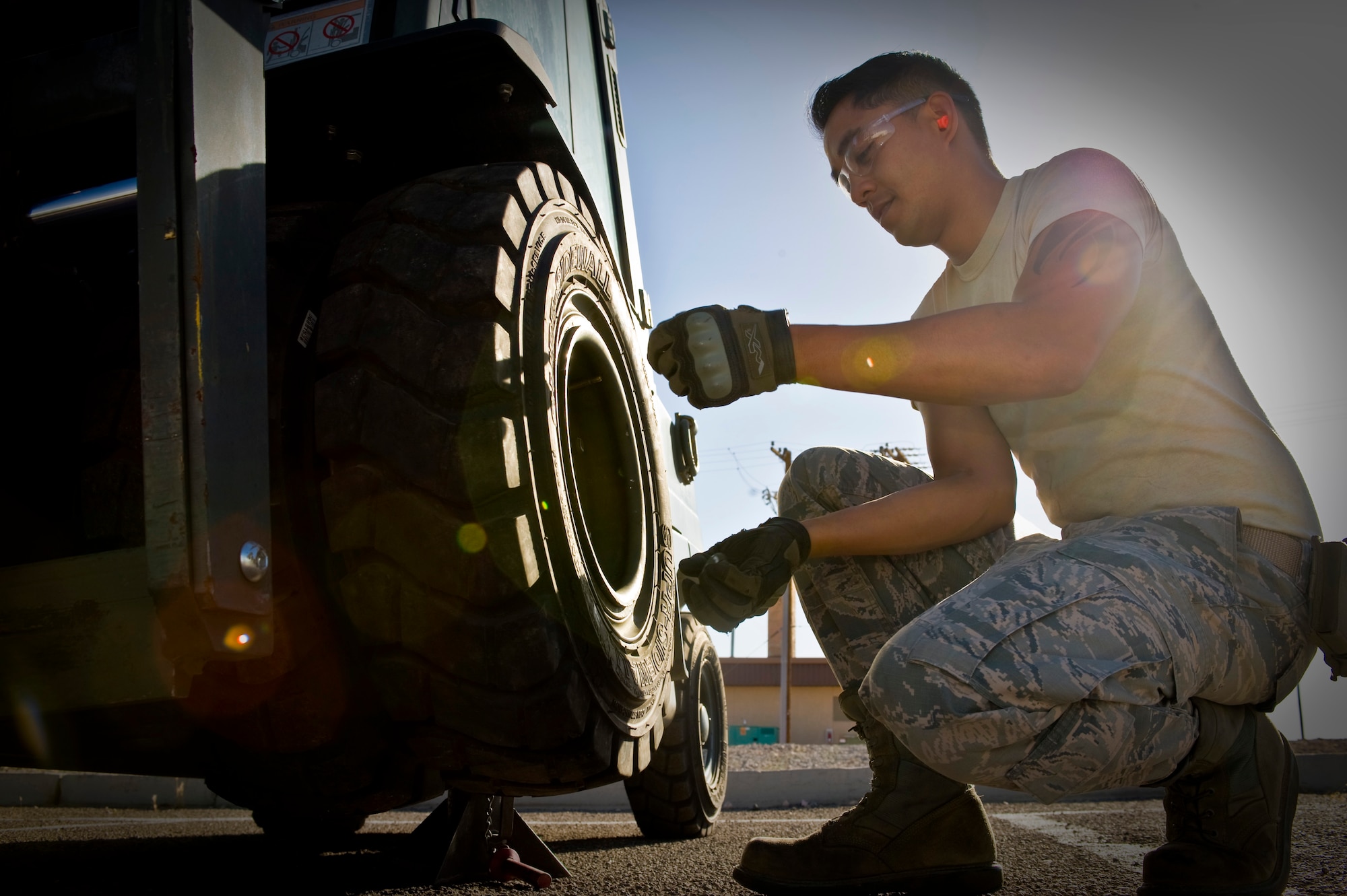 Staff Sgt. Francisco Macatol, 99th Logistics Readiness Squadron customer service technician, replaces a tire on a 4K forklift June 17, 2014, at Nellis Air Force Base, Nev. The 99th LRS vehicle management flight customer service section can provide mobile maintenance to customers with repairs on vehicles that are unable to drive or unable to be brought in for maintenance. (U.S. Air Force photo by Senior Airman Christopher Tam)