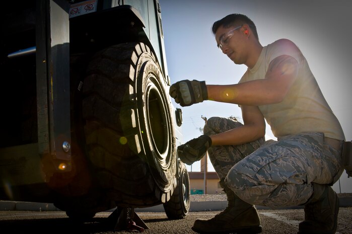 Staff Sgt. Francisco Macatol, 99th Logistics Readiness Squadron customer service technician, replaces a tire on a 4K forklift June 17, 2014, at Nellis Air Force Base, Nev. The 99th LRS vehicle management flight customer service section can provide mobile maintenance to customers with repairs on vehicles that are unable to drive or unable to be brought in for maintenance. (U.S. Air Force photo by Senior Airman Christopher Tam)