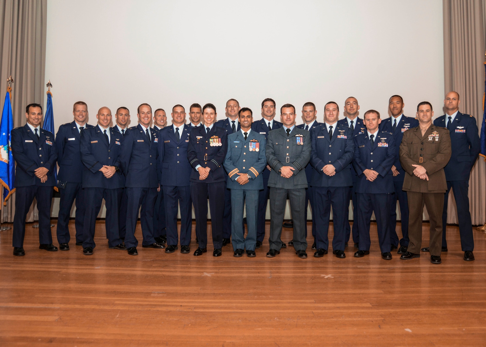 U.S. Air Force Test Pilot School Class 13B graduated in the base theater June 13. Among the graduates were 11 experimental test pilots, seven flight test engineers, one experimental remotely piloted aircraft test pilot and one experimental test combat systems officer from the U.S. Air Force, U.S. Marine Corps, Australia, Canada, and United Kingdom. (U.S. Air Force photo by Rebecca Amber)