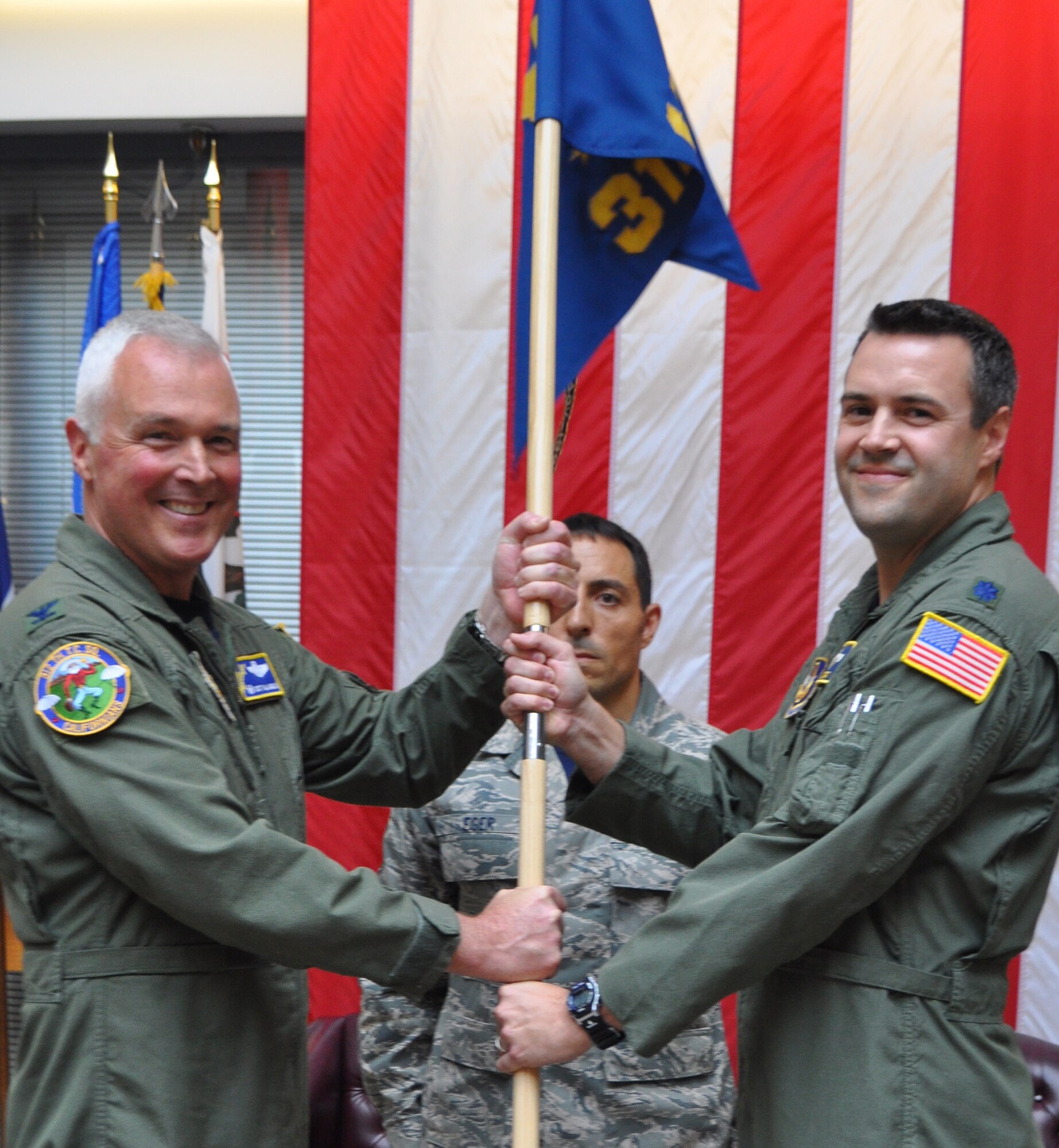 TRAVIS AIR FORCE BASE, Calif. -- As the incoming commander, Lt. Col. Dan Stout steps up, and accepts the 312th AS flag from Col. Scott McLaughlin, thus accepting command. Stout flew B-52 Stratofortress bombers at Barksdale Air Force Base, Lousiana, and the B-2 Spirit stealth bomber at Whiteman AFB, Missouri, prior to joining the 349th Air Mobility Wing here. Lane has been selected for promotion to colonel, and in-residence professional military education. (U.S. Air Force photo/Ellen Hatfield)