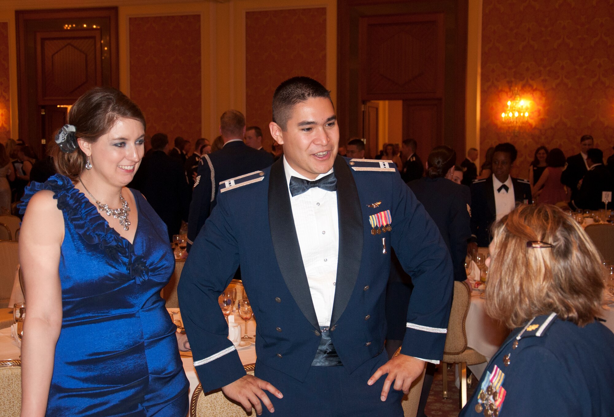 Capt. Jordan Tabayoyon, 90th Maintenance Operations Squadron,  and his wife, Dana Jo, speak with Maj. Jackie Sartori, 90th Maintenance Operations Squadron commander, at the 90th Missile Wing Dining Out June 13, 2014, in the Little America Hotel & Resort in Cheyenne, Wyo. Hundreds of guests attended the event. (U.S. Air Force photo by Airman 1st Class Jason Wiese)