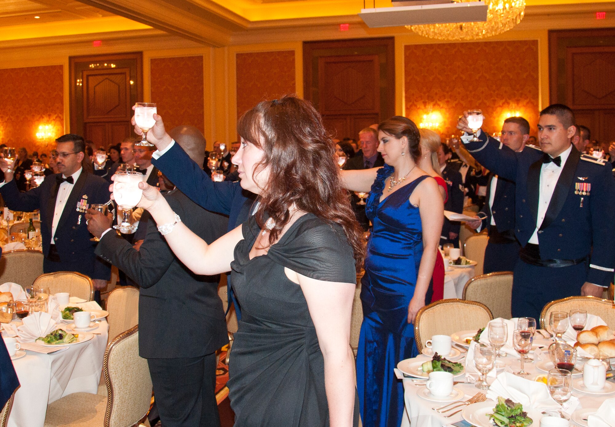 Mighty Ninety personnel and loved ones raise a toast to prisoners of war and those missing in action, who cannot attend events such as a Dining Out, June 13, 2014, in the Little America Hotel & Resort in Cheyenne, Wyo. (U.S. Air Force photo by Airman 1st Class Jason Wiese)