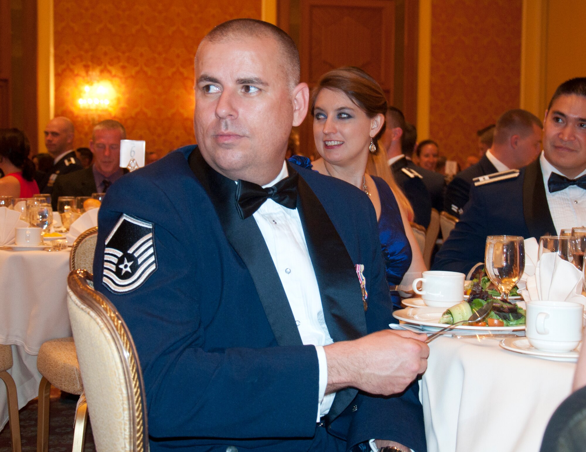 Master Sgt. Dwayne Mayberry, 90th Munitions Squadron, taps his spoon on the table in lieu of applause at the 90th Missile Wing Dining out June 13, 2014, in the Little America Hotel & Resort in Cheyenne, Wyo. One of the many often-humorous "rules of the mess" for the event was that attendees were not allowed to clap, but had to show their applause like Mayberry.  (U.S. Air Force photo by Airman 1st Class Jason Wiese)