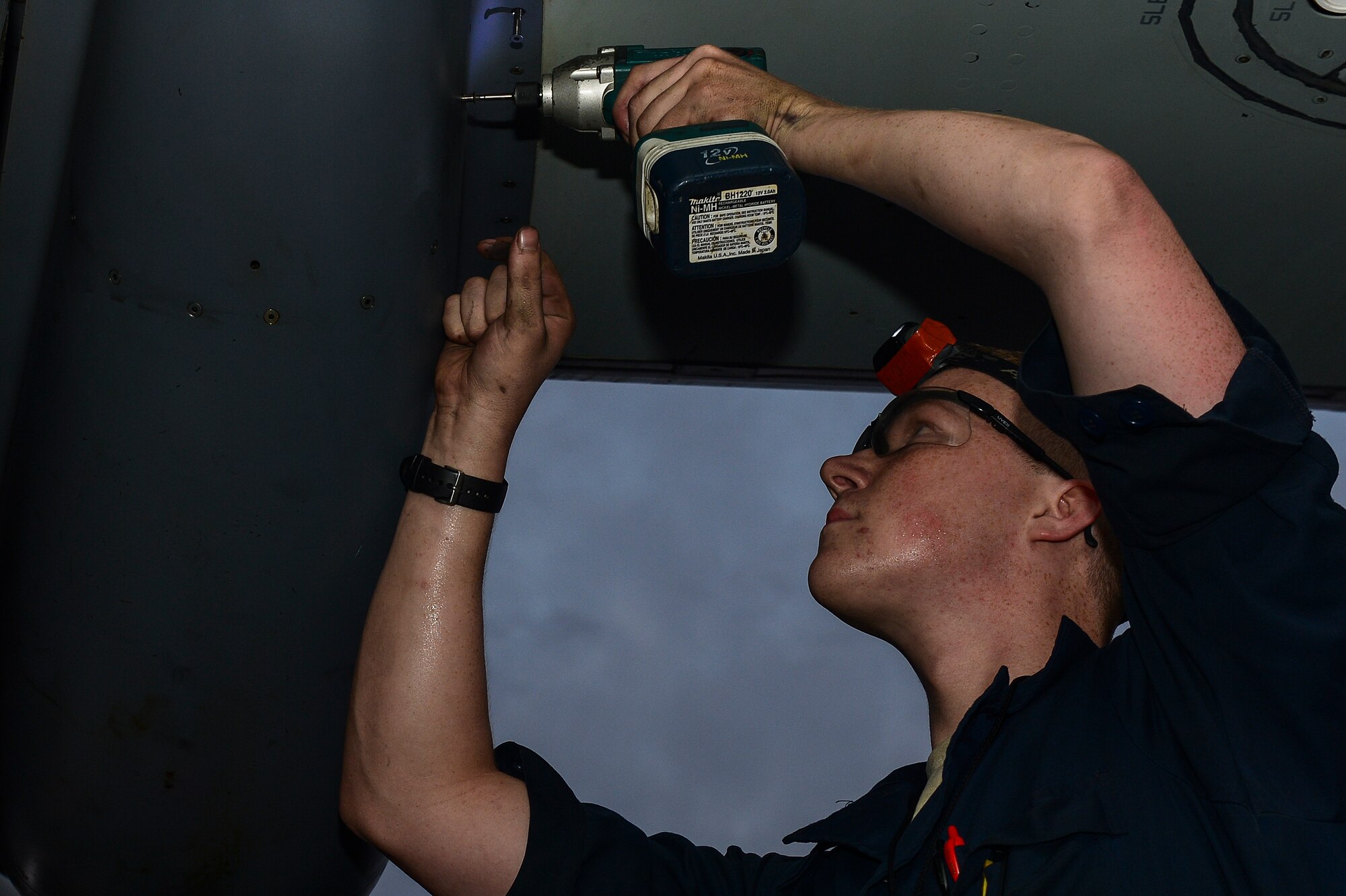 Staff Sgt. Perry Otillio, 801st Special Operations Aircraft Maintenance Squadron dedicated crew chief, removes screws from a CV-22 Osprey engine on Hurlburt Field, Fla., June 13, 2014. The 801st SOAXMS Airmen performed further checks and maintenance to fix the broken Osprey. (U.S. Air Force photo/Airman 1st Class Jeff Parkinson)







