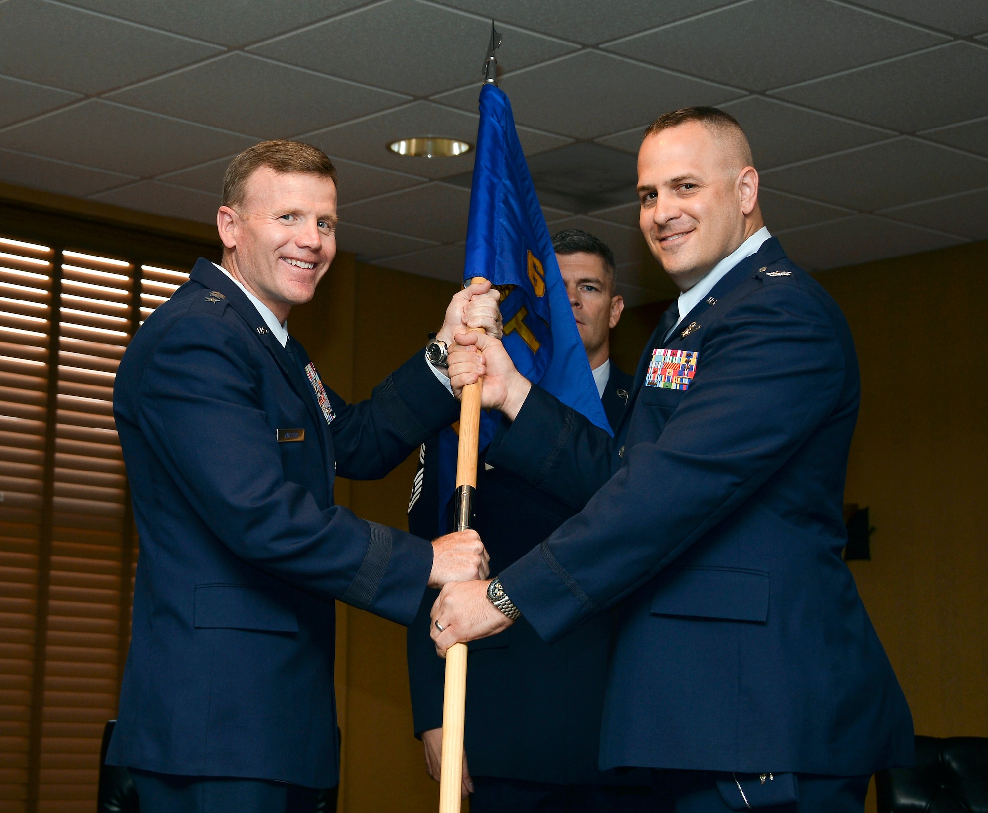 Lt. Gen. Tod Wolters, Commander 12th Air Force (Air Forces Southern) passes the squadron guideon to Col. James Sheedy during the 612th Theater Operations Group Change of Command Ceremony on Davis-Monthan AFB, Ariz., June 17, 2014.  Sheedy assumed command of the 612 TOG from Col. Jonathan VanNoord. (U.S. Air Force photo by Tech. Sgt. Heather R. Redman/Released)
