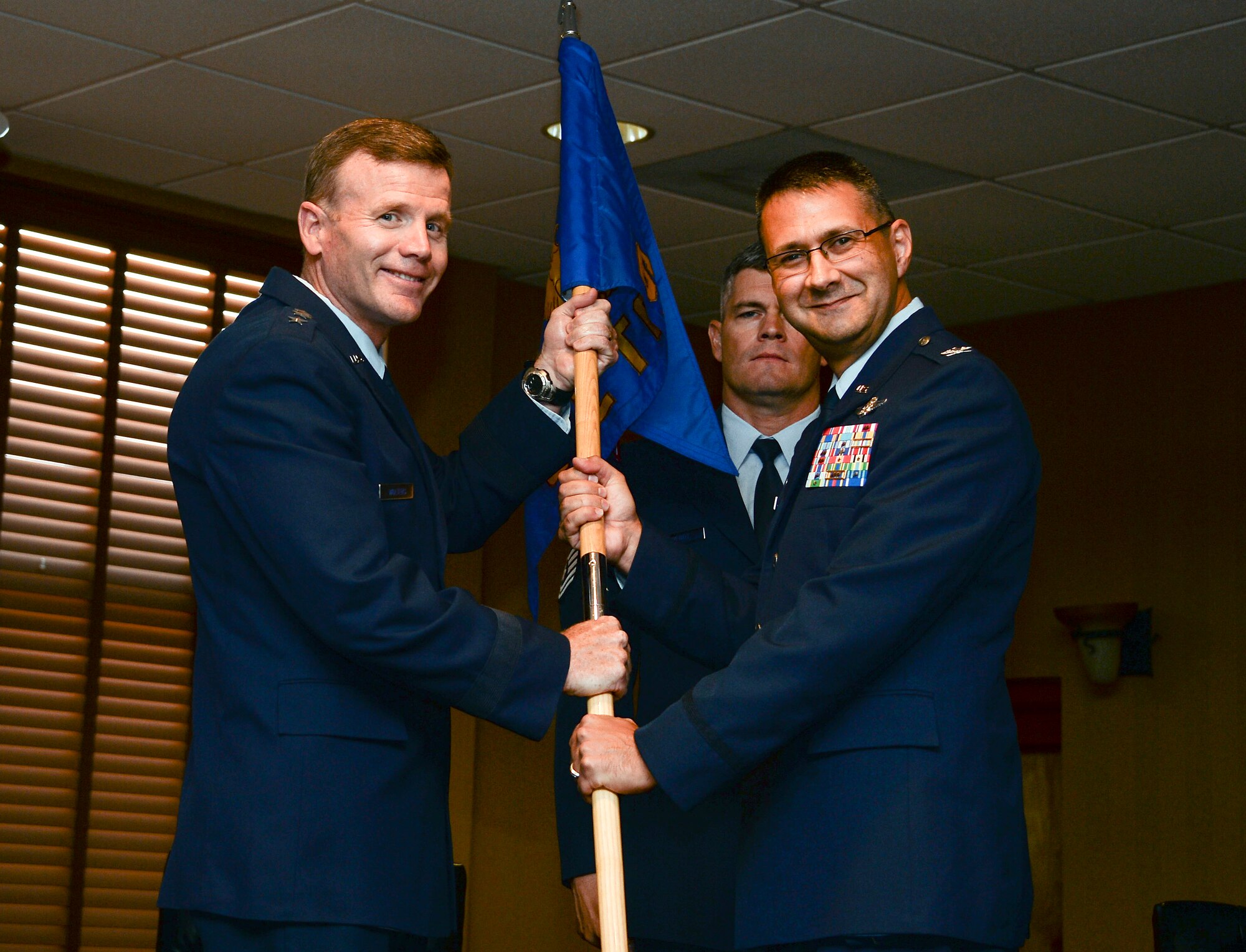 Lt. Gen. Tod Wolters, Commander 12th Air Force (Air Forces Southern) recieves the squadron guideon from Col. Jonathan VanNoord during the 612th Theater Operations Group Change of Command Ceremony on Davis-Monthan AFB, Ariz., June 17, 2014.  VanNoord relinquished command of the 612 TOG to Col. James Sheedy. (U.S. Air Force photo by Tech. Sgt. Heather R. Redman/Released)