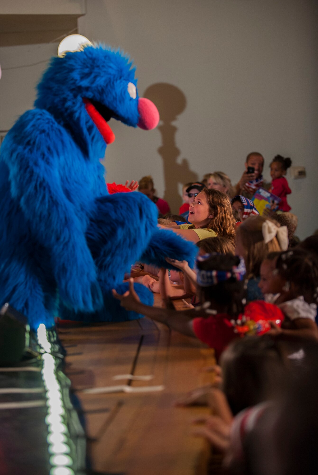 Hundreds of Team Minot family members gathered to watch the Sesame Street USO Experience for Military Families Tour at the Minot Air Force Base theater, June 16-17, 2014. The show, which had four separate viewing times, featured Elmo, Grover, Cookie Monster, Rosita and Katie, who is a military child herself. (U.S. Air Force photo/Airman 1st Class Apryl Hall)
