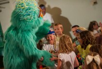 Hundreds of Team Minot family members gathered to watch the Sesame Street USO Experience for Military Families Tour at the Minot Air Force Base theater, June 16-17, 2014. The show, which had four separate viewing times, featured Elmo, Grover, Cookie Monster, Rosita and Katie, who is a military child herself. (U.S. Air Force photo/Airman 1st Class Apryl Hall)