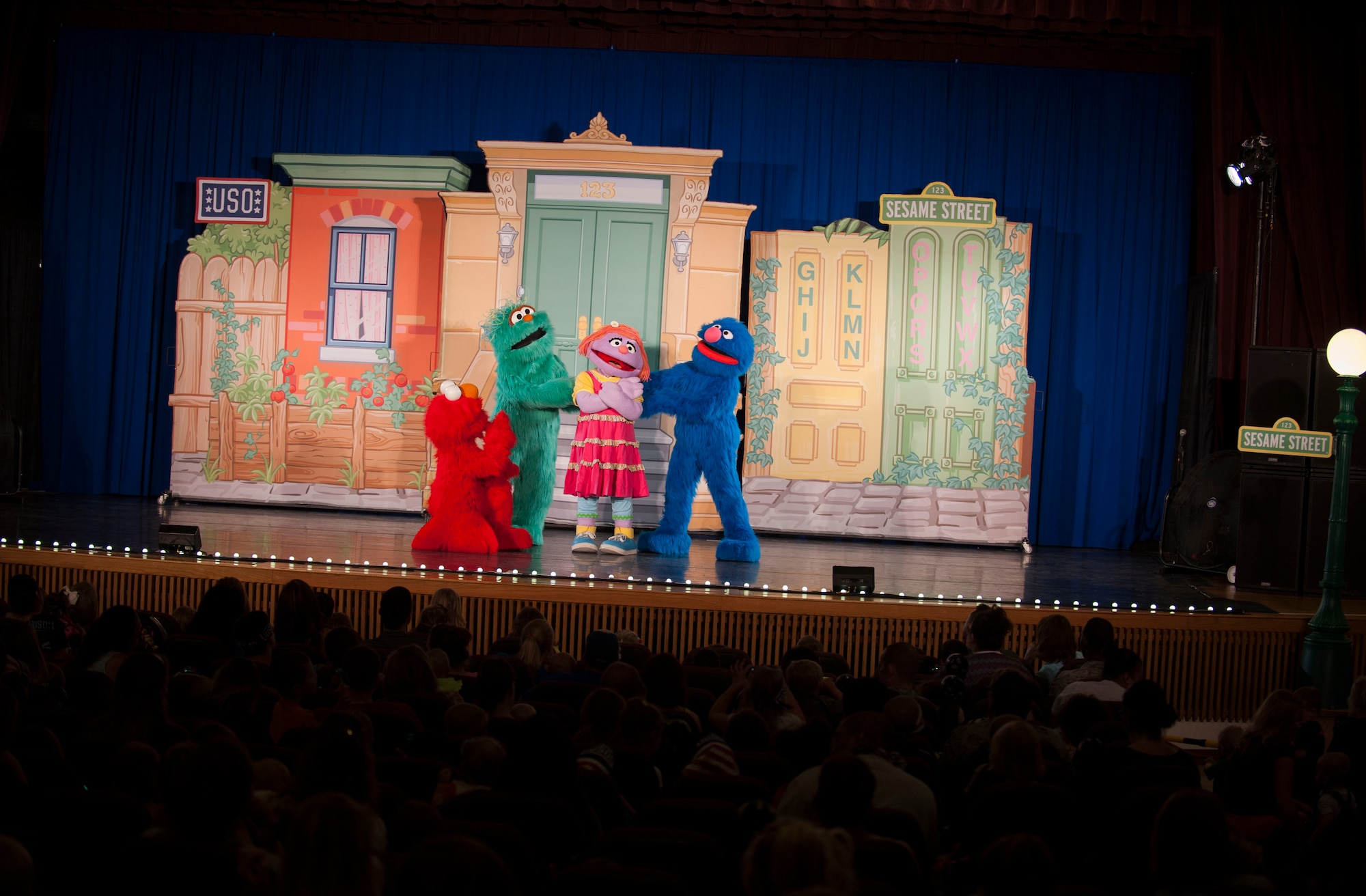 Hundreds of Team Minot family members gathered to watch the Sesame Street USO Experience for Military Families Tour at the Minot Air Force Base theater, June 16-17, 2014. The show, which had four separate viewing times, featured Elmo, Grover, Cookie Monster, Rosita and Katie, who is a military child herself. (U.S. Air Force photo/Airman 1st Class Apryl Hall)