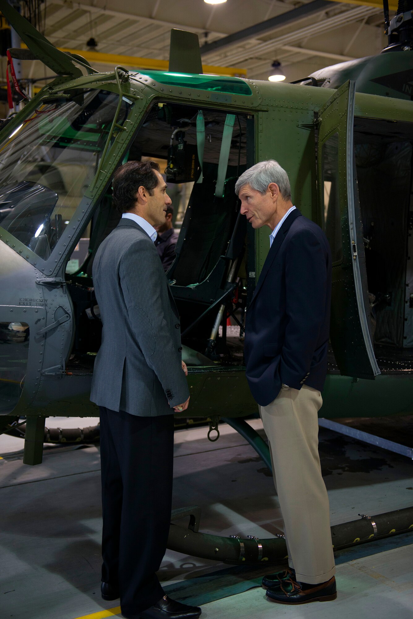 Retired Air Force Gen. Norton Schwartz, president and CEO of the Business Executives for National Security, describes the components of the UH-1N Huey to another member of BENS at Minot Air Force Base, N.D., June 10, 2014. Schwartz served as the 19th Chief of Staff of the U.S. Air Force.  (U.S. Air Force photo/Airman 1st Class Sahara L. Fales)