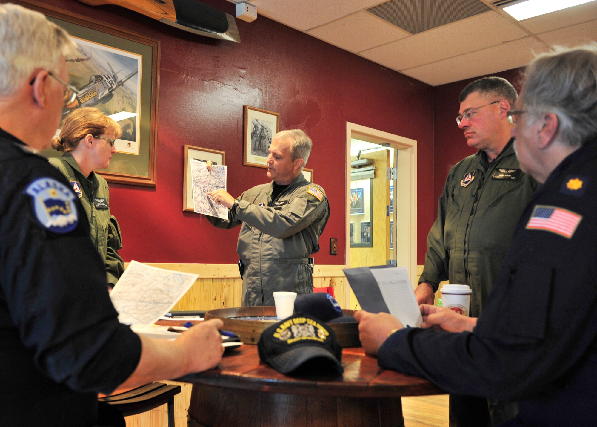U.S. Air Force Col. John Cartwright, 354th Maintenance Group commander and 71st Composite Squadron operations officer, shows fellow members of the Civil Air Patrol their flight patterns May 21, 2014, Eielson Air Force Base, Alaska. CAP works closely with units during Red Flag-Alaska and act as an aerial target during exercises. (U.S. Air Force photo by Senior Airman Ashley Nicole Taylor/Released)