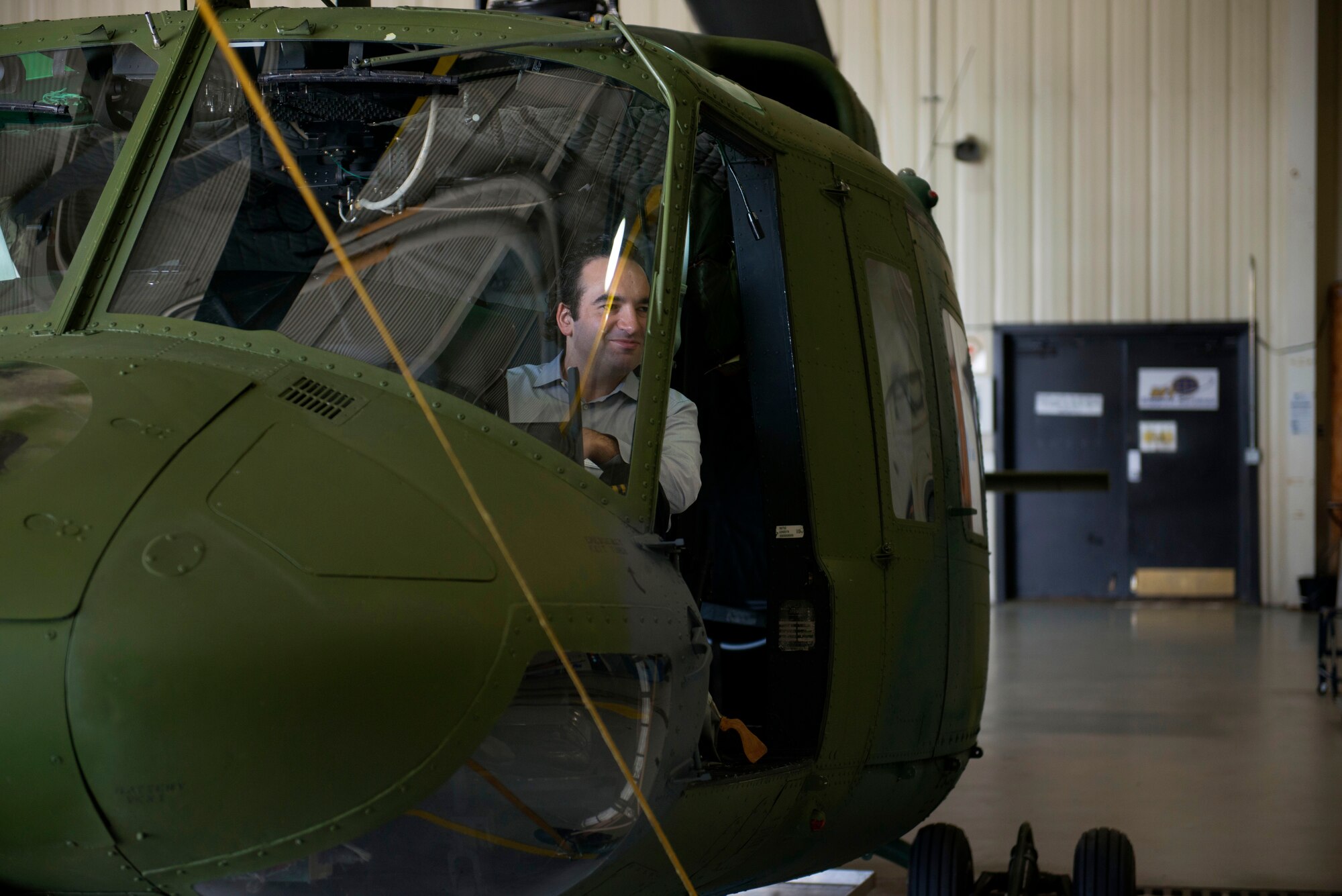 A member of the Business Executives for National Security sits in a UH-1N Huey at Minot Air Force Base, N.D., June 10, 2014. The BENS members toured different facilities on base in hopes of fostering the spirit of innovation, while maintaining the importance of strategic deterrence. (U.S. Air Force photo/Airman 1st Class Sahara L. Fales)