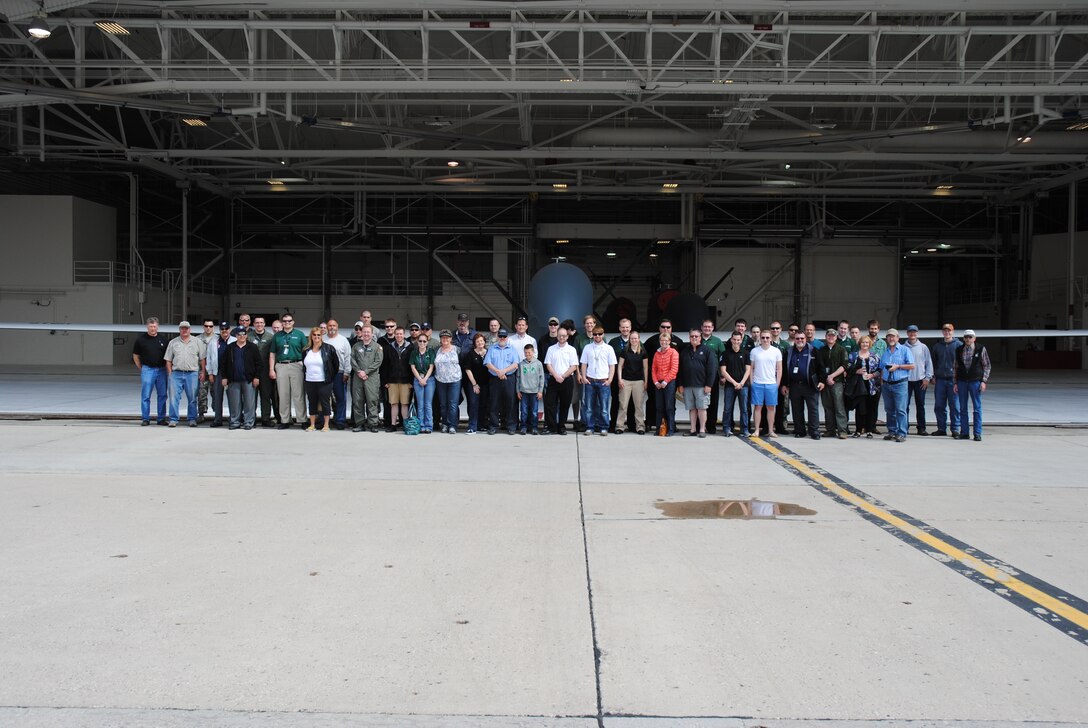 Guests, civilians and Airmen participating in the 2014 M.A.C.A. Civil Fly-In pose for a group photo in front of a RQ-4 Block 40 Global Hawk on June 14, 2014, at the flightline on Grand Forks Air Force Base, N.D. The viewing of the Global Hawk was one of the highlights featured on the tour guests were treated during the civil fly-in for the Mid-Air Collision Avoidance program managed by the 319th Air Base Wing Safety Office. (U.S. Air Force photo/Staff Sgt. Luis Loza Gutierrez) 
